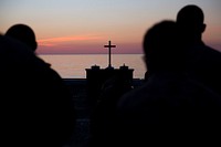 MEDITERRANEAN SEA. Marines and Sailors assigned to the 24th Marine Expeditionary Unit (MEU) and the amphibious transport dock ship USS Mesa Verde (LPD 19) gather aboard the ship’s flight deck for worship during a sunrise service honoring Resurrection Day April 16, 2017.