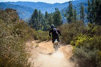 Man riding off-road motorcycle. Original public domain image from Flickr