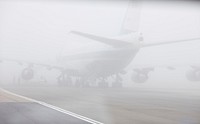 Air Force One is shrouded in fog April 3, 2009, on the tarmac at Stansted Airport in England.