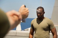 MEDITERRANEAN SEA (May 20, 2017) Gunnery Sgt. Adaecus G. Brooks, combat camera chief for the 24th Marine Expeditionary Unit (MEU), is sprayed with oleoresin capsicum during a confidence course aboard the San Antonio-class amphibious transport dock ship USS Mesa Verde (LPD 19) May 20, 2017.