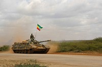 A member of the ENDF drives past in a tank during an End of Tour of Duty ceremony performed in front of AMISOM Force Commander, Lt. Gen. Osman Noor Soubagleh, in Baidoa, Somalia, on July 15, 2017. AMISOM Photo. Original public domain image from <a href="https://www.flickr.com/photos/au_unistphotostream/35911941636/" target="_blank" rel="noopener noreferrer nofollow">Flickr</a>