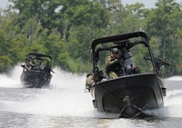 Students from a Patrol Craft Officer course taught by the Naval Small Craft Instruction and Technical Training School (NAVSCIATTS) extract students from the Western Hemisphere Institute for Security Cooperation during a field training exercise at the Stennis Space Center in Gulfport, Miss., June 29, 2009.