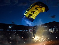 A member of the U.S. Navy parachute demonstration team, the Leap Frogs, prepares to land during a night time aerial demonstration at Cheyenne Frontier Days Arena in Cheyenne, Wyoming, July 27, 2017.