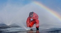 U.S. Navy Aviation Boatswain's Mate (Handling) Airman Montagius Knott, from Compton, California, clear debris from a sprinkler on the flight deck during a counter measure wash down aboard the Navy's forward-deployed aircraft carrier, USS Ronald Reagan (CVN 76) in the Pacific Ocean south of Japan.