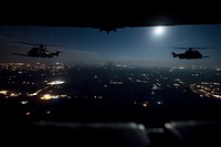 Two French Air Force EC-725 Super Cougar helicopters receive fuel from a U.S. Air Force MC-130H Combat Talon II during a night mission over northwest Florida as part of Emerald Warrior March 5, 2018.