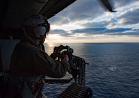 180311-N-NM806-0027 EAST CHINA SEA (March 11, 2018) Naval Aircrewman (Helicopter) 2nd Class Bret Bristol assigned to Helicopter Sea Combat Squadron 25 (HSC-25) "Island Knights" fires an M2HB .50 caliber machine gun during live-fire exercise on board an MH-60S Sea Hawk. The Wasp Expeditionary Strike Group is conducting a regional patrol meant to strengthen regional alliances, provide rapid-response capability, and advance the Up-Gunned ESG Concept.