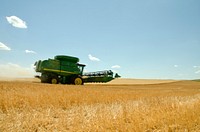 A combine, harvesting winter wheat on a farm in Beach, ND. The combine leaves stubble, which is helpful in maintaining soil moisture and improving soil health. Original public domain image from <a href="https://www.flickr.com/photos/160831427@N06/38143681584/" target="_blank" rel="noopener noreferrer nofollow">Flickr</a>