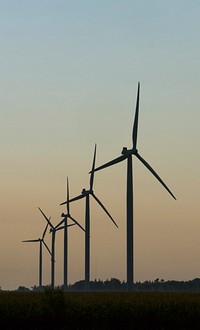 Wind turbines and a communications tower are seen from an Iowa highway during U.S. Secretary of Agriculture Sonny Perdue's five-state rural tour, featuring Wisconsin, Minnesota, Iowa, Illinois, and Indiana.