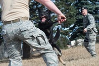 Air Force Staff Sgt. Marshall Rains, right, controls military working dog, Greg, as he attacks Staff Sgt. Brandon Hardy, during aggression training at Joint Base Elmendorf-Richardson, Alaska, April 17, 2018. The military working dog teams, assigned to the 673d Security Forces Squadron, routinely perform this training to maintain their skills and operational readiness. Boyd is a native of Atlanta, Ga. (U.S. Air Force photo by Alejandro Peña). Original public domain image from Flickr