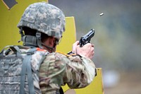Montana Army National Guard Spc. Tucker Zimmerman fires a M9 pistol while competing in a maneuver and fire event during the National Guard Best Warrior Region VI 2018 at Joint Base Elmendorf-Richardson, Alaska, May 16, 2018. National Guard Best Warrior Region VI 2018 is a four-day competition that tests Soldiers' mental and physical toughness through a series of events that demonstrate technical and tactical proficiency to determine the top non-commissioned officer and junior enlisted Soldier. The competitors represent the top Soldiers from Alaska, Idaho, Montana, North Dakota, Oregon, South Dakota, Washington, and Wyoming. (U.S. Air Force photo by Alejandro Peña). Original public domain image from Flickr
