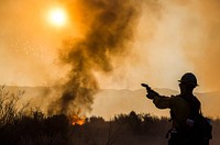 Thomas Fire burns in the hills above Los Padres National Forest during a firing operation. The fire was 272,600 acres and 65% contained. Original public domain image from Flickr