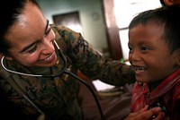Navy Lt. Yesenia Astorga, from Los Angeles, and general medical officer with the 11th Marine Expeditionary Unit, checks the heartbeat of a young patient here Oct. 19. Members of the 11th MEU are in Indonesia for an exercise focused on medical and dental assistance, engineering projects and military interaction.