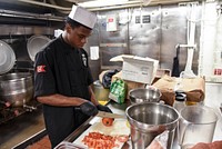 MEDITERRANEAN SEA (May 19, 2018) Culinary Specialist Seaman Bonnie Shanno prepares food in a galley aboard the Nimitz-class aircraft carrier USS Harry S. Truman (CVN 75).