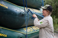 Woman secures river patrol boats to a trailer, Middle Fork of the Salmon River, Salmon-Challis National Forest, Idaho. Original public domain image from Flickr