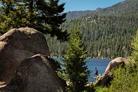 A man paddle boards on Delmoe Lake in Beaverhead-Deerlodge National Forest.