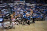 Russell Logan, a Department of Defense Warrior Games athlete and Team Air Force member, passes the ball to his teammate, Anthony Pearson, during the wheelchair basketball championship of the Games at the U.S. Air Force Academy, Colorado Springs, Colorado, June 9, 2018.