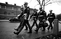 Marine Corps body bearers march from their barracks to the bus to transport them to the day’s funeral Nov. 30, 2009 before preparing for the days funerals.