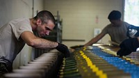 U.S. Air Force Staff Sgt. Charles Paulson, a munitions systems technician with the 1st Special Operations Maintenance Squadron, inspects 105mm target practice rounds at Hurlburt Field, Fla., May 15, 2018.