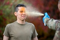Army Pvt. Antonio Martinez, a military police officer with the 545th Military Police Company, 17th Combat Sustainment Support Battalion, U.S. Army Alaska, is sprayed with oleoresin capsicum (OC) while conducting familiarization training at Joint Base Elmendorf-Richardson, Alaska, Oct. 9, 2018. All security forces and military police personnel are exposed to OC spray when they first arrive at their units. OC spray is a non-lethal weapon used to incapacitate individuals. (U.S. Air Force photo by Alejandro Peña). Original public domain image from Flickr
