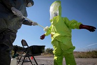 U.S. Air National Guard Senior Airman is decontaminated by Airman during Exercise Clean House. Original public domain image from Flickr