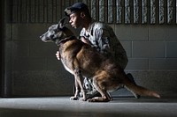 Air Force Staff Sgt. Christopher Bennett, a native of New Orleans, and a military working dog handler assigned to the 673d Security Forces Squadron, works with Kimba, a Belgian Malinois, at one of the kennels on Joint Base Elmendorf-Richardson, Alaska, Sept. 11, 2018. Kimba is approaching retirement after ten-years of military service. (U.S. Air Force photo by Justin Connaher). Original public domain image from Flickr