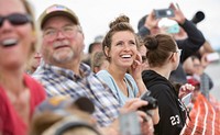 Lora Ramzey smiles during an aerial demonstration during the Special Needs and Department of Defense Family Day at the Arctic Thunder Open House, June 29, 2018. This biennial event hosted by Joint Base Elmendorf-Richardson, Alaska, is one of the largest in the state and one of the premier aerial demonstrations in the world. The event features multiple performers and ground acts to include the JBER joint forces, U.S. Air Force F-22, and U.S. Air Force Thunderbirds demonstrations teams, June 30-July 1. (U.S. Air Force photo by Justin Connaher). Original public domain image from Flickr