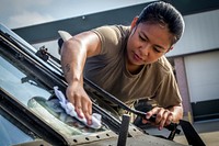 U.S. Army Spc. Mary Grace A. Oinal with the 1-150th Assault Helicopter Battalion, New Jersey Army National Guard, cleans the windows of a UH-60L Black Hawk helicopter at Joint Base McGuire-Dix-Lakehurst, N.J., Sept. 5, 2018. (New Jersey National Guard photo by Mark C. Olsen). Original public domain image from Flickr