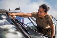 U.S. Army Spc. Mary Grace A. Oinal with the 1-150th Assault Helicopter Battalion, New Jersey Army National Guard, cleans the windows of a UH-60L Black Hawk helicopter at Joint Base McGuire-Dix-Lakehurst, N.J., Sept. 5, 2018. (New Jersey National Guard photo by Mark C. Olsen). Original public domain image from Flickr