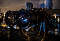 LISBON, Portugal – A Sailor uses ship-mounted binoculars on the bridge wing aboard the Blue Ridge-class command and control ship USS Mount Whitney (LCC 20) as the ship departs Lisbon, Portugal, Oct. 16, 2018.