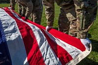 U.S. Army Soldiers with the New Jersey National Guard's Honor Guard prepare to lift the flag above the casket. Original public domain image from Flickr