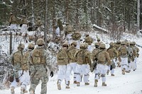 Army paratroopers assigned to Blackfoot Company, 1st Battalion, 501st Parachute Infantry Regiment, 4th Infantry Brigade Combat Team (Airborne), 25th Infantry Division, U.S. Army Alaska, move to a staging area before conducting infantry platoon live-fire training at Joint Base Elmendorf-Richardson, Alaska, Nov. 8, 2018. The exercise honed the paratroopers’ infantry skills to include: platoon movement and communication, obstacle breaching, capturing objectives through assault and maneuver, and casualty care. (U.S. Air Force photo by Alejandro Peña). Original public domain image from Flickr