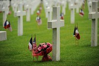 Flower bouquet at graveyard on memorial day, French and American flags decoration. Original public domain image from Flickr