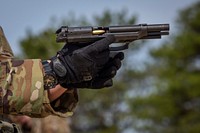 U.S. Army Spc. Emma E. Archut, 328th Military Police Company, reloads an M9 pistol during the New Jersey Army National Guard's Best Warrior Competition at Joint Base McGuire-Dix-Lakehurst, N.J., April 9, 2019. Original public domain image from Flickr