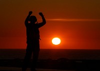 MEDITERRANEAN SEA. A Sailor directs aircraft on the flight deck of the Nimitz-class aircraft carrier USS Abraham Lincoln (CVN 72).