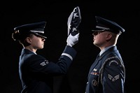 U.S. Air Force Senior Airman Daniele Belovarac, left, a loadmaster and honor guard flight leader with the 3rd Airlift Squadron, and Senior Airman Ben Newsome, a aircraft structural maintenance specialist with the 436th Maintenance Squadron, demonstrate a flag folding ceremony Jan. 15, 2019, at Dover Air Force Base, Delaware.