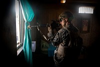 A U.S. Marine with Golf Company, 2nd Battalion, 3rd Marine Regiment, provides security from a window during a military operations in urban terrain (MOUT) exercise on Marine Corps Training Area Bellows, Mar. 14, 2019.