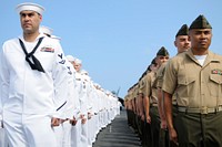 U.S. Marines and Sailors assigned to the Ronald Reagan carrier strike group stand at attention before manning the rails aboard the aircraft carrier USS Ronald Reagan (CVN 76) June 28, 2010, in Pearl Harbor, Hawaii.