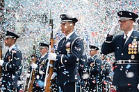 Members of the U.S. Air Force Honor Guard Drill Team stand at attention during the playing of The Star-Spangled Banner prior to the 500 Festival Parade in Indianapolis, May 25, 2019.