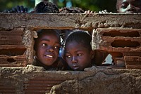 Mozambican children admire their new school