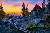 U.S. Forest Service Recreation Forrester Jocelyn Dodge views the sunrise over the Whitetail Mountains from the East Ridge near Butte, Montana, September 15, 2019.USDA Photo by Preston Keres. Original public domain image from Flickr