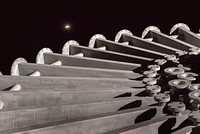 The lunar eclipse rises in the New Mexico sky over the Starburst sculpture at Sandia Labs in Albuquerque.