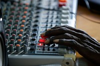 Technician, Iliassou Goumande, adjusts the dials during a live round table broadcast at Radio Baarou in Ouallam, Niger.