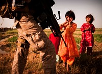 Marines patrol through Afghan village