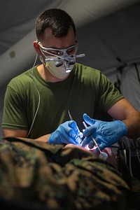 U.S. Navy Lt. Jarrett Darrah with 2nd Dental Battalion, 2nd Marine Logistics Group preforms a filling on a patient during an Authorized Dental Allowance List (ADAL) on Camp Lejeune, North Carolina, Dec. 10, 2019.