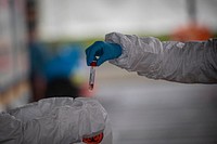 Medical staff collect samples from a patient at a COVID-19 Community-Based Testing Site at the PNC Bank Arts Center in Holmdel, N.J., March 23, 2020.