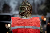 A New Jersey National Guard Airman directs traffic at a COVID-19 Community-Based Testing Site at the PNC Bank Arts Center in Holmdel, N.J., March 23, 2020.