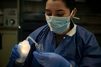 200406-N-EV253-1017 NEW YORK CITY (April 6, 2020) - U.S. Navy Hospital Corpsman 3rd Class Janet Rosas flushes test tubes with saline solution aboard the Military Sealift Command hospital ship USNS Comfort (T-AH 20) while the ship is in New York City in support of the nation’s COVID-19 response efforts.