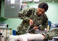 200404-N-PH222-1138 LOS ANGELES (April 4, 2020) Hospitalman Kiana Stubbs, from Chicago, practices removing a cast during orthopedics training aboard the hospital ship USNS Mercy (T-AH 19).