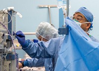 200418-N-PH222-1912 LOS ANGELES (April 18, 2020) Cmdr. You Wei Lin, from Lexington, Mass., an anesthesiologist, monitors a surgery in an operating room aboard the hospital ship USNS Mercy (T-AH 19).