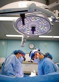 200417-N-EV253-1350 NEW YORK CITY (April 17, 2020) - Plastic Surgeon Capt. Lauren Archer, left, and neurosurgeon Lt. Cmdr. Scott Zuckerman, collaborate during a surgical procedure aboard the Military Sealift Command hospital ship USNS Comfort (T-AH 20).